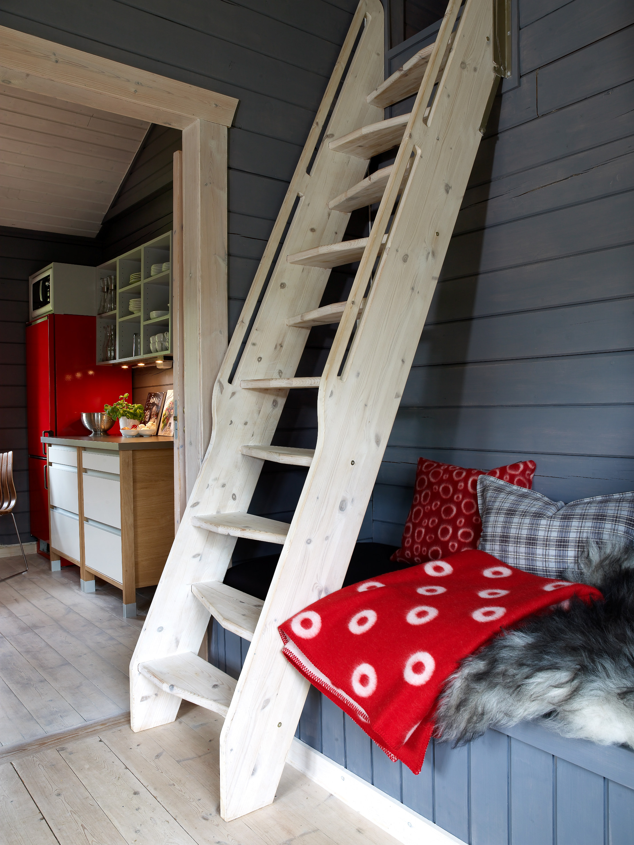 Trappen opp til hemsen har samme farge som gulvet, og stikker seg derfor ikke ut, men bidrar til å skape helhet.  I bakgrunnen skimtes kjøkkenet. 