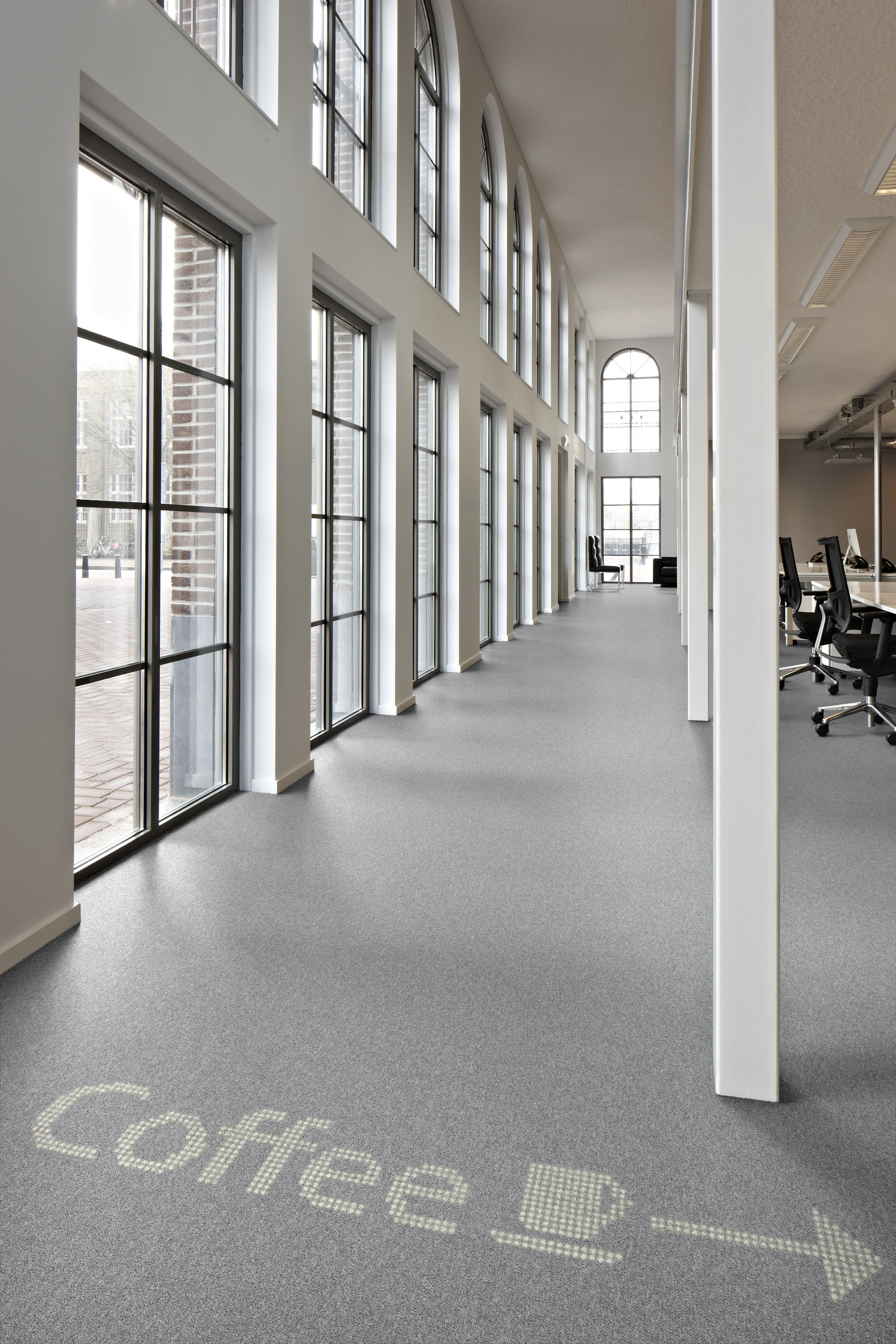 Teppeflisenes transparente bakside lar lyseffektene skinne gjennom. Gulvet kan bli både informativt og imponerende.