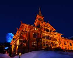 Holmenkollen Park hotell i Oslo er som et eventyrslott i dragestil. Et kjempestort rødt tømmerhus med gule og blå detaljer og brune vinduer. Tårnet er inspirert av stavkirkenes takrytter. Den eldste delen er fra 1894. 
