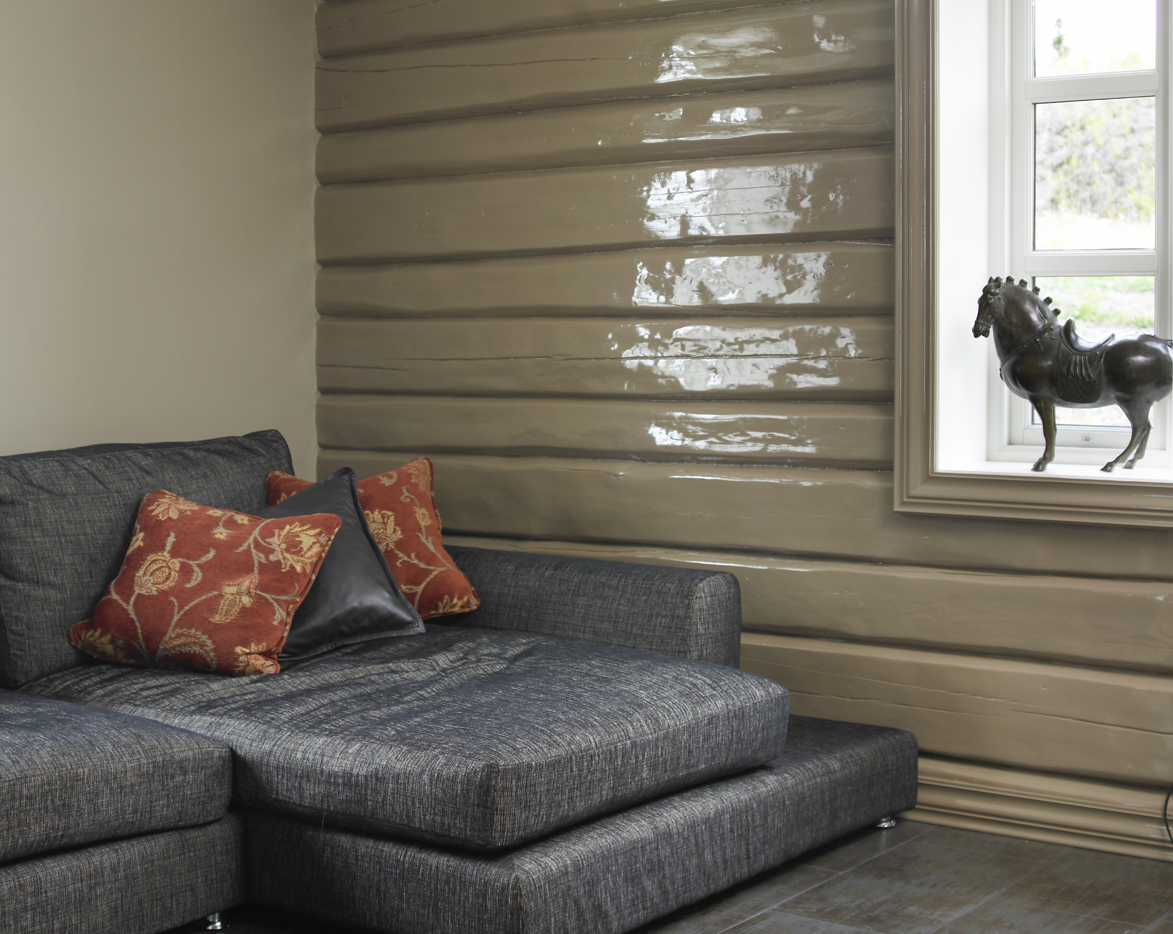 Tømmeret blir «fett» og lekkert i uttrykket med blank maling, her i farge S 5010-Y30R. Vindusomrammingen har fått samme behandling. Det blanke treverket fremheves ekstra av den matte veggen i farge S 4010-Y30R.