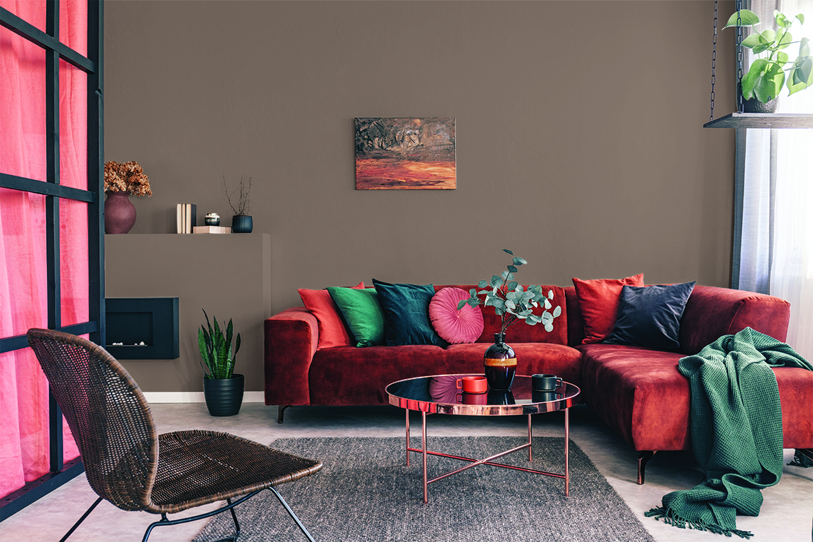 Stue med vegger malt i fargen HH Rakle, kombinert med interiør i grønt og gylne høstfarger. 