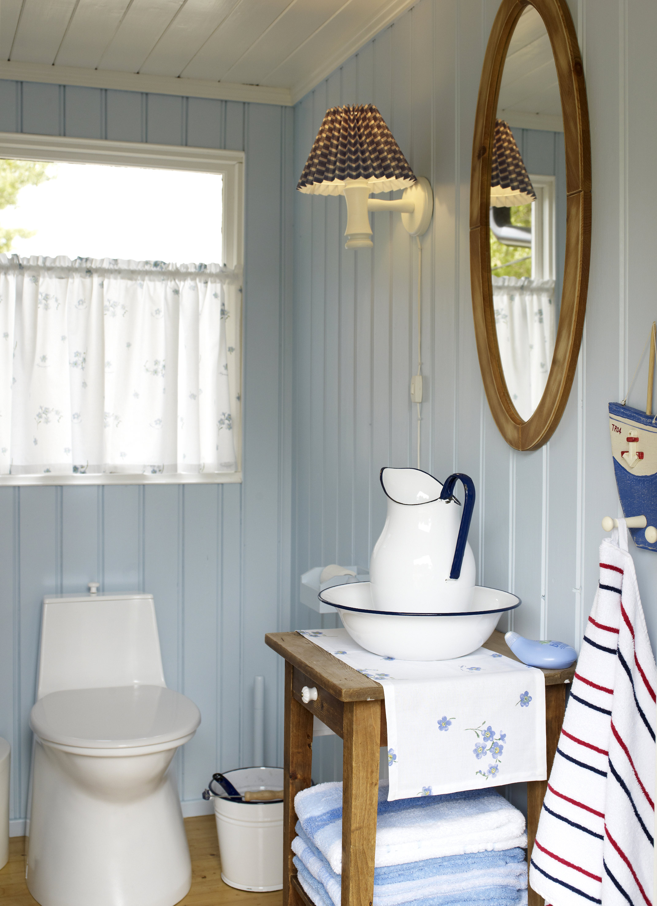 Toalettet er kjølig blått som himmelen, med varme innslag av treverk. 