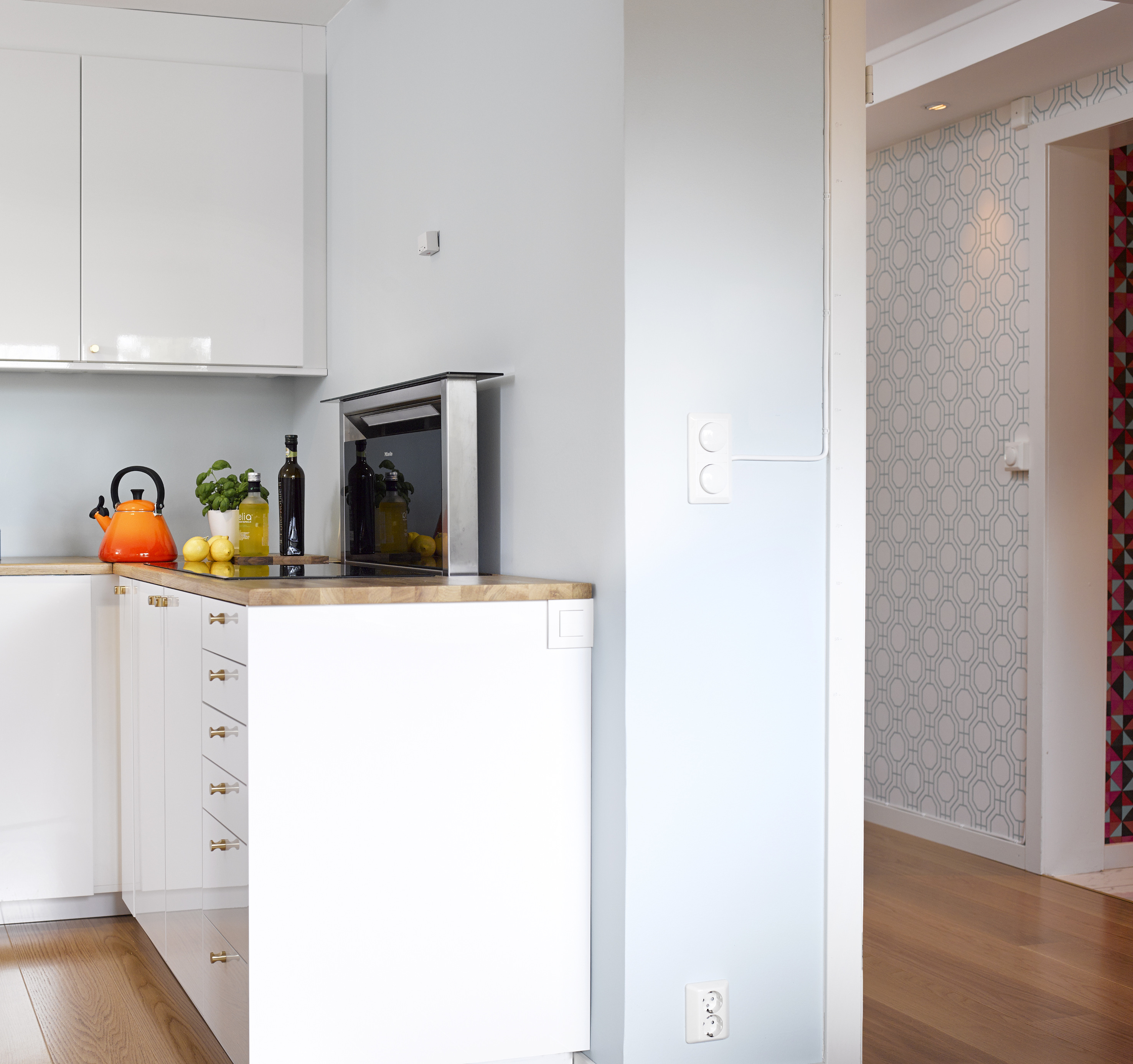 Fra kjøkkenet ser man både stue og gang, og fordi fargene går igjen i alle rom, er det full balanse. 