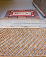 Bruk et grovt mønstret teppe utenfor døren, og et finere inne. 