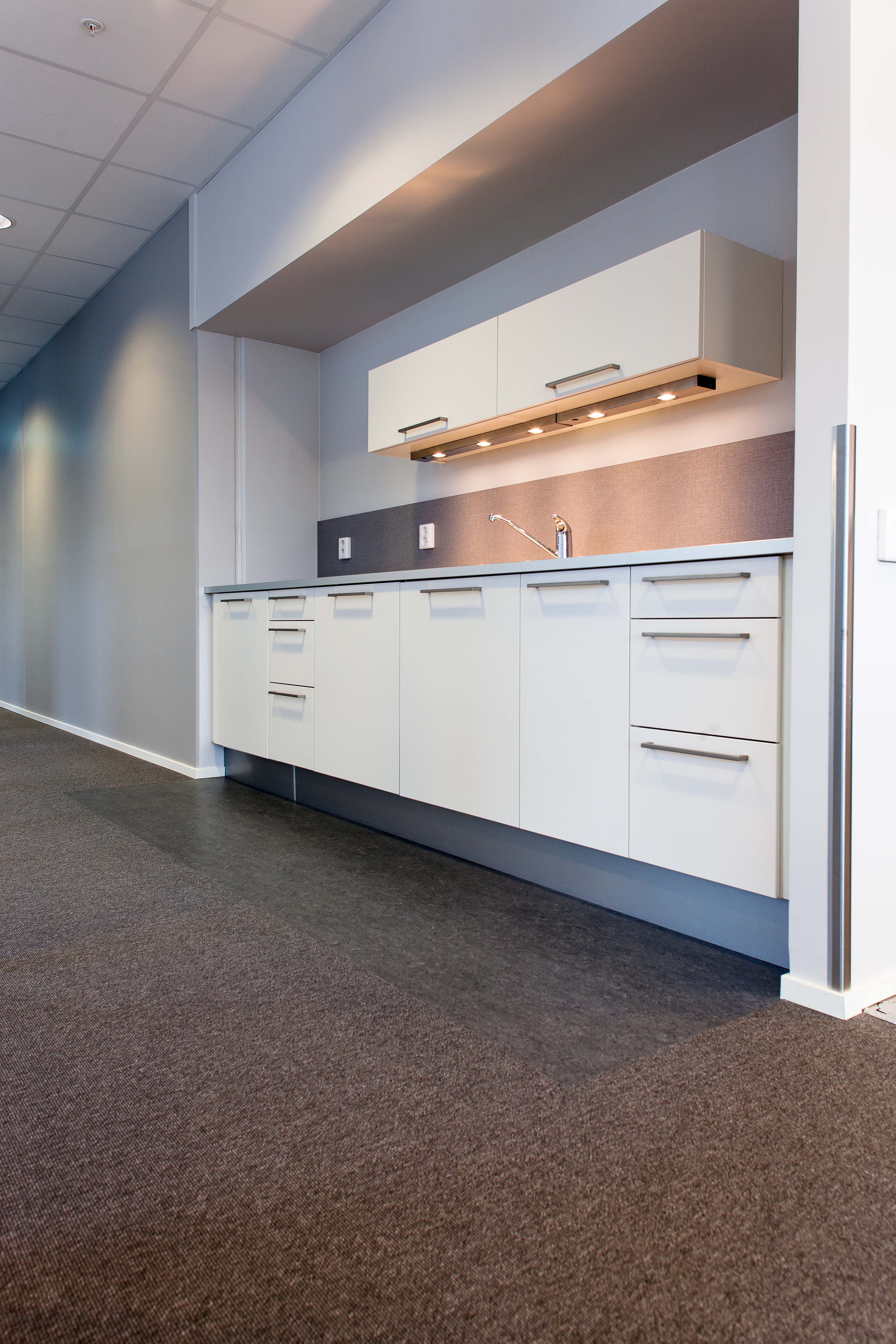 Integrerte linoleums belegg i «sølesoner» fungerer godt sammen med gulvteppene.