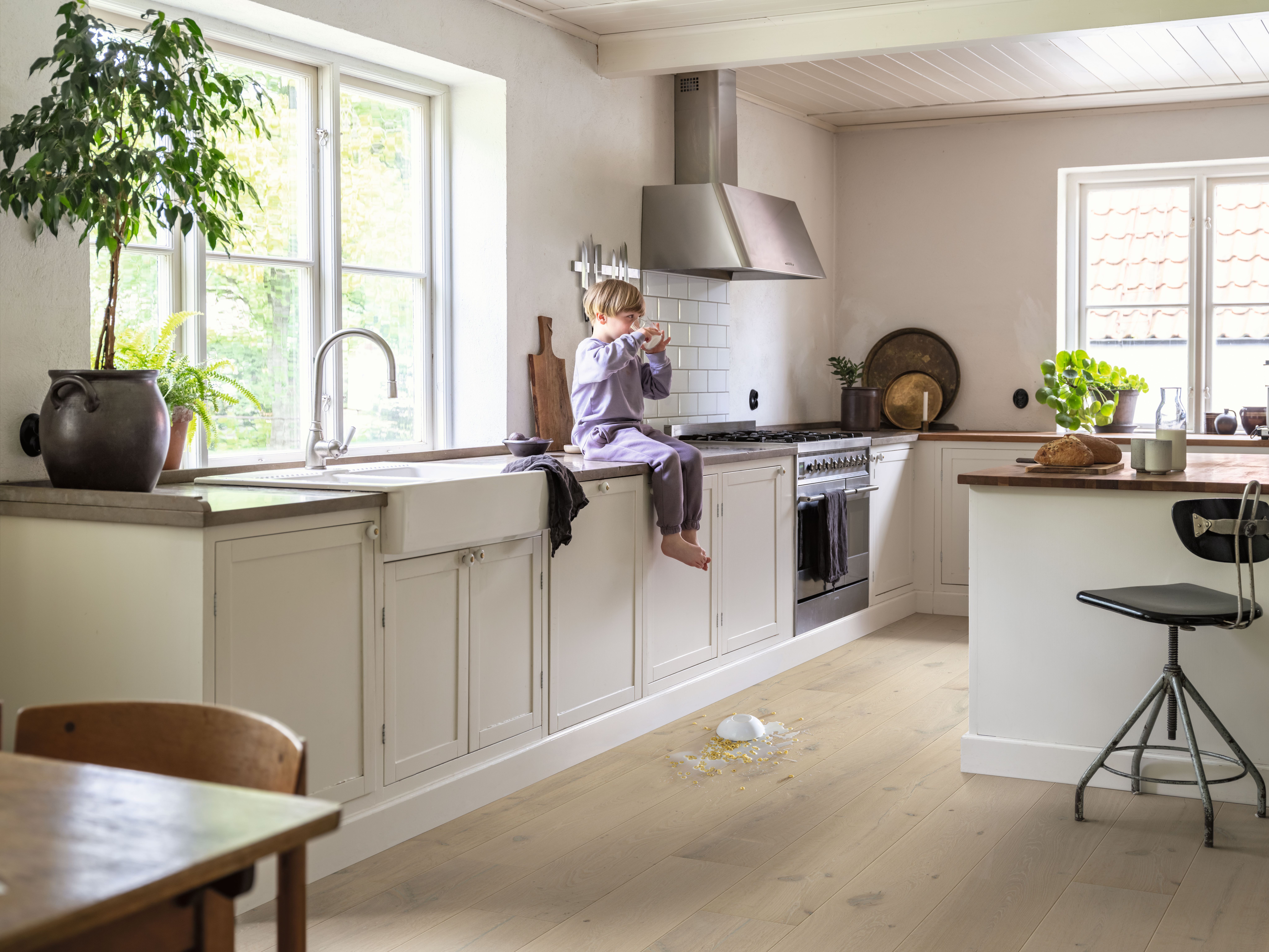 barn sitter på kjøkkenbenk.