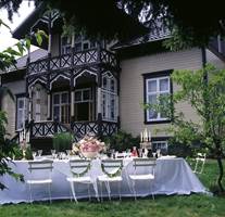 Villa Snøringsmoen i Lillesand ble ført tilbake til sin opprinnelige stil og farger. Her er farget glass i verandaen, markerte konstruksjonsdetaljer, høye vinduer og spisst tak med store utstikk.