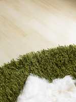 Et gressgrønt, flosset teppe gir assosiasjoner til naturen ute.