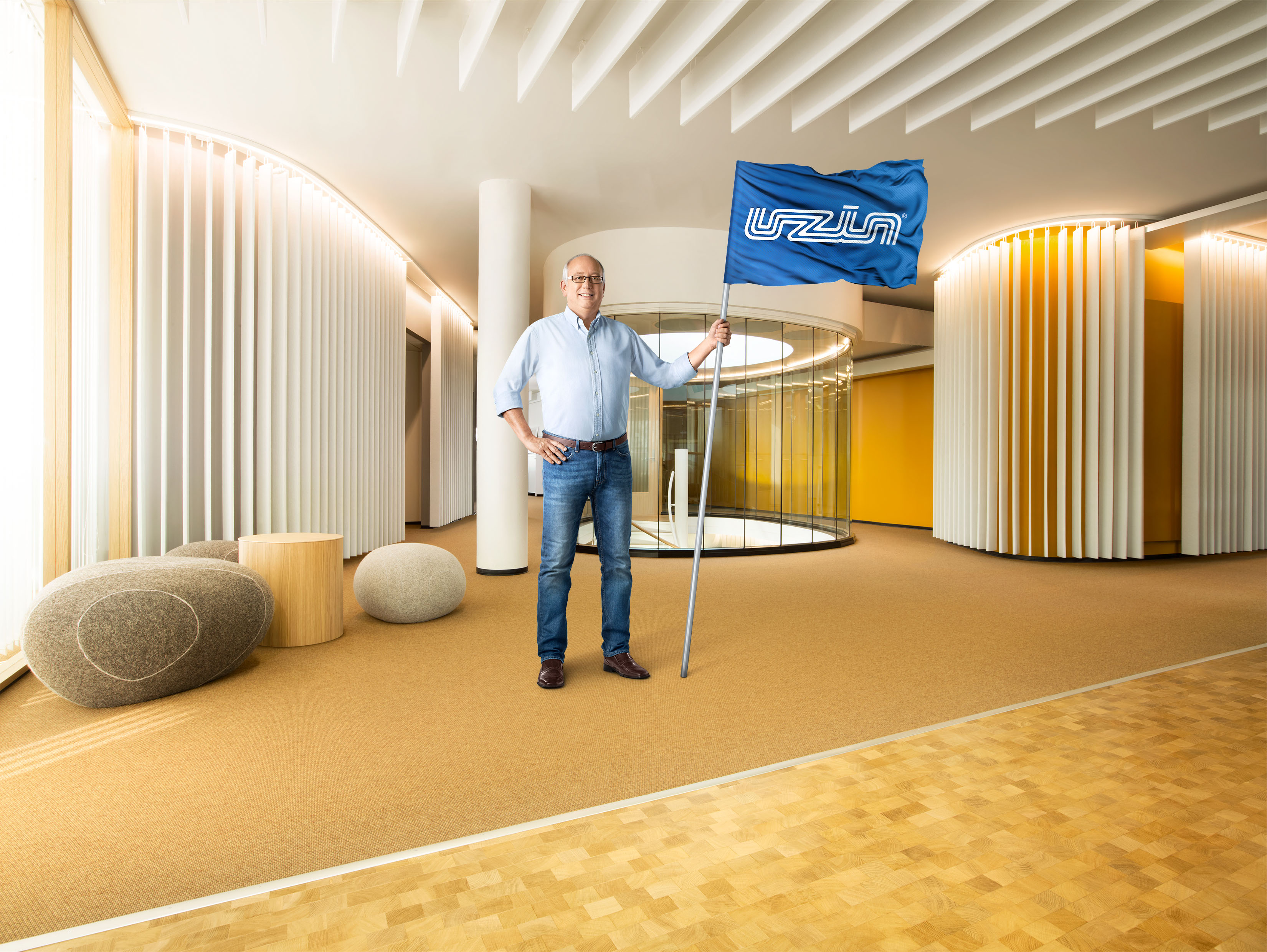 Gulvleggere med Uzin-flagg i hånden benttes i presentasjonen av suksessprosjekter for å vise betydningen av at gulvleggere, sammen med Uzin, oppnår suksess.