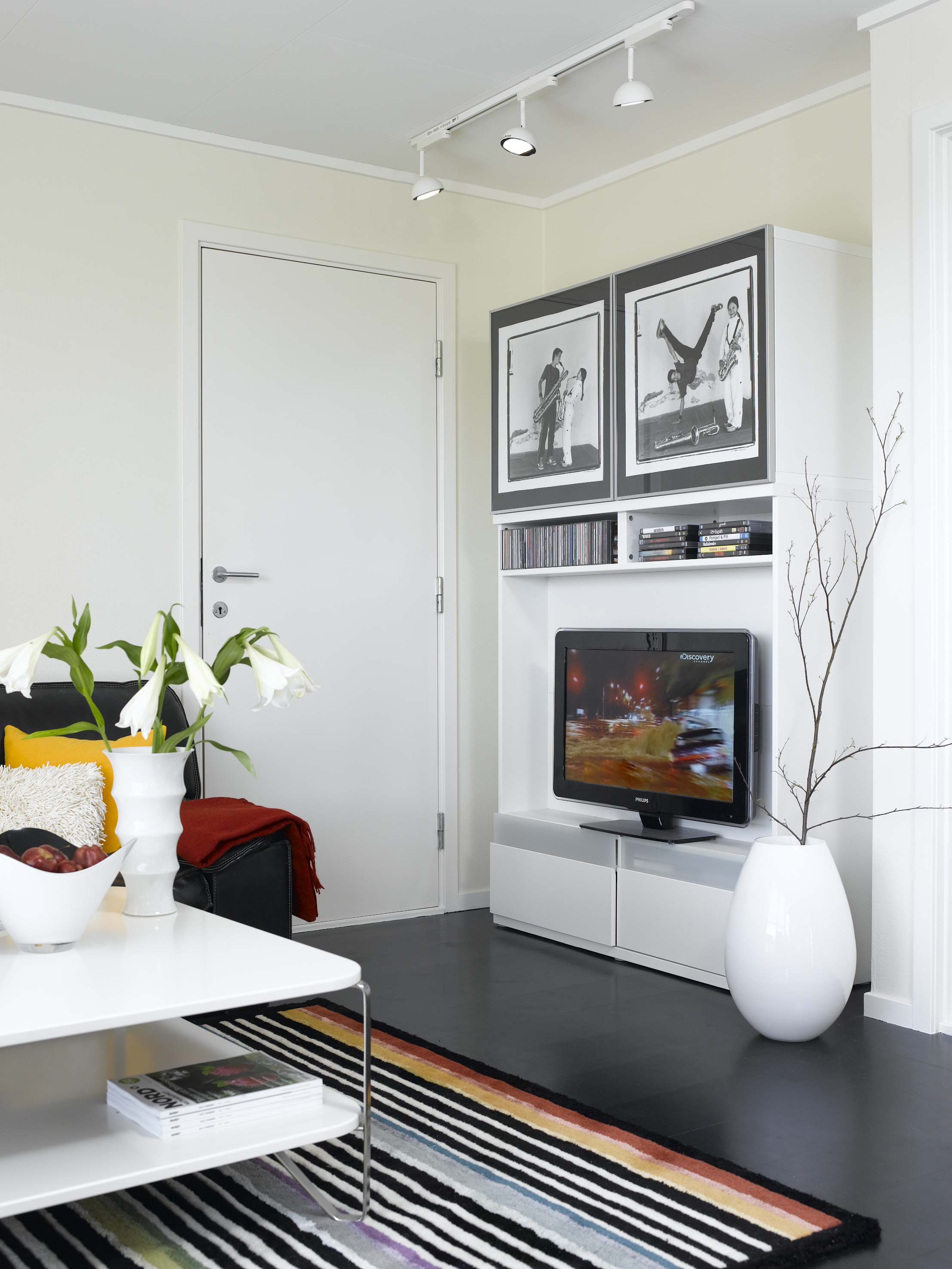 Den tidligere gule døren er nå hvit, og nærmest kamuflert. En praktisk skapløsning gir plass til både TV, musikk og filmer. 